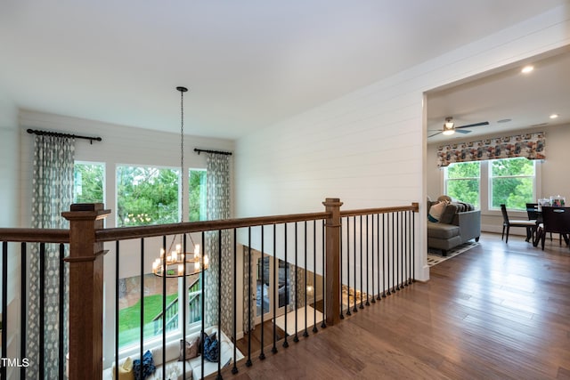 hallway featuring hardwood / wood-style flooring and an inviting chandelier