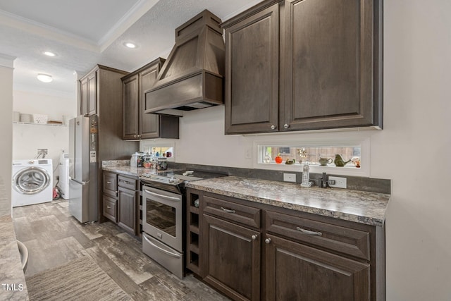 kitchen featuring crown molding, premium range hood, stainless steel appliances, and dark brown cabinetry