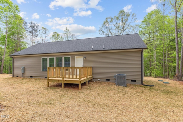 back of property with central AC unit, a lawn, and a deck