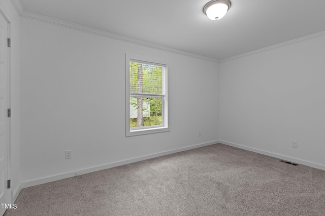 carpeted empty room featuring ornamental molding