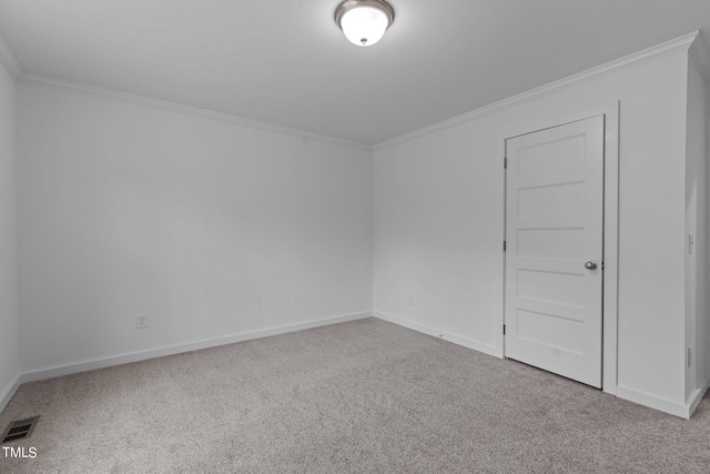 carpeted spare room featuring crown molding