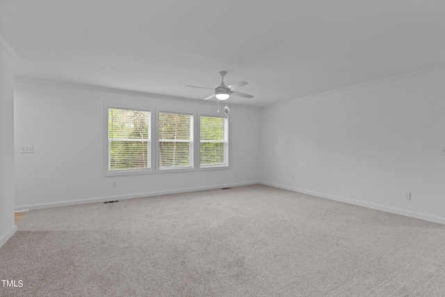 empty room with carpet floors, ceiling fan, and ornamental molding