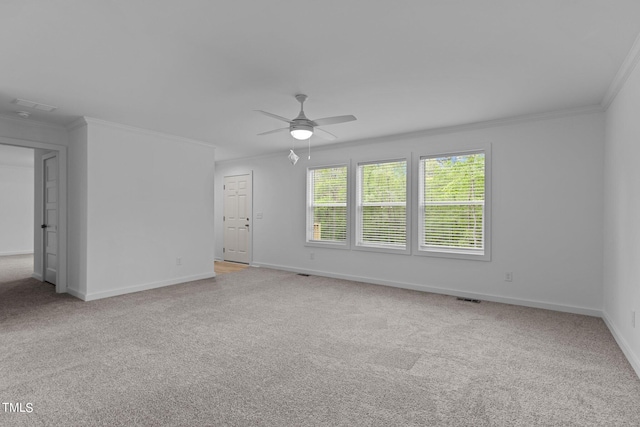 carpeted spare room with crown molding and ceiling fan