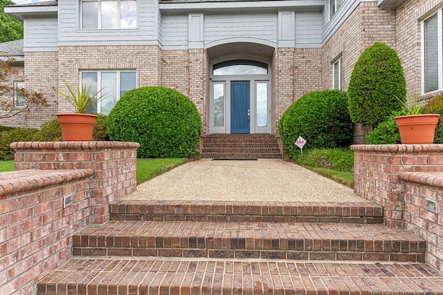entrance to property with brick siding