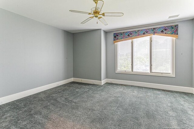 spare room featuring baseboards, a ceiling fan, carpet flooring, and visible vents