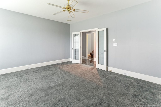 empty room featuring visible vents, baseboards, dark colored carpet, ceiling fan, and french doors