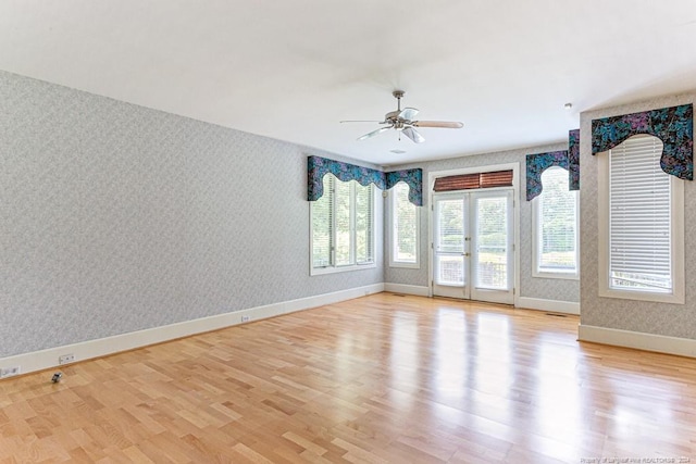 empty room with light wood-type flooring and ceiling fan