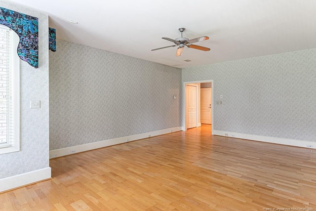 spare room featuring light wood-type flooring and ceiling fan