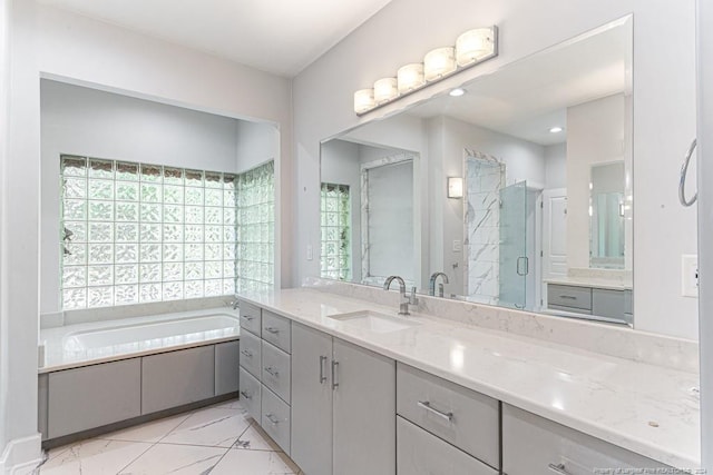 bathroom featuring vanity, a stall shower, and a garden tub
