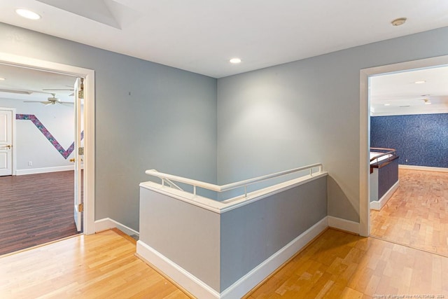 hallway featuring recessed lighting, baseboards, and wood finished floors
