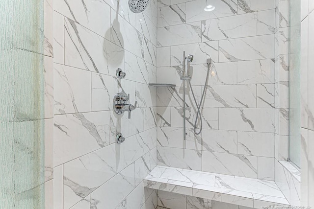 bathroom with tiled shower