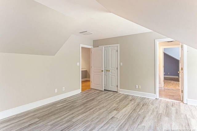 bonus room featuring vaulted ceiling and hardwood / wood-style floors