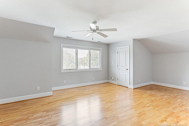 bonus room featuring ceiling fan, visible vents, vaulted ceiling, light wood-type flooring, and baseboards