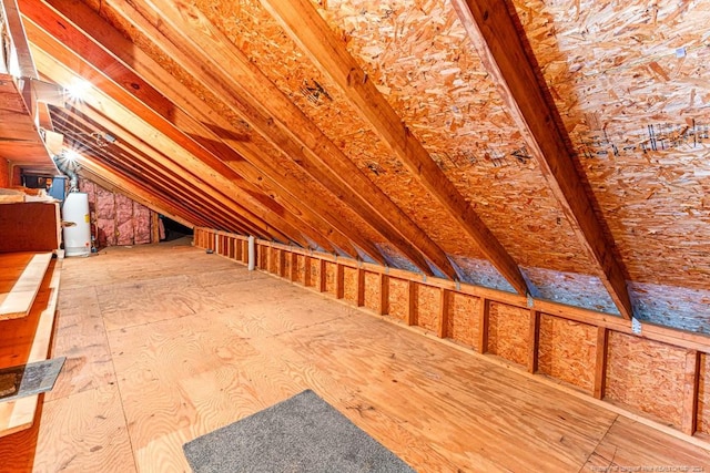unfinished attic featuring gas water heater