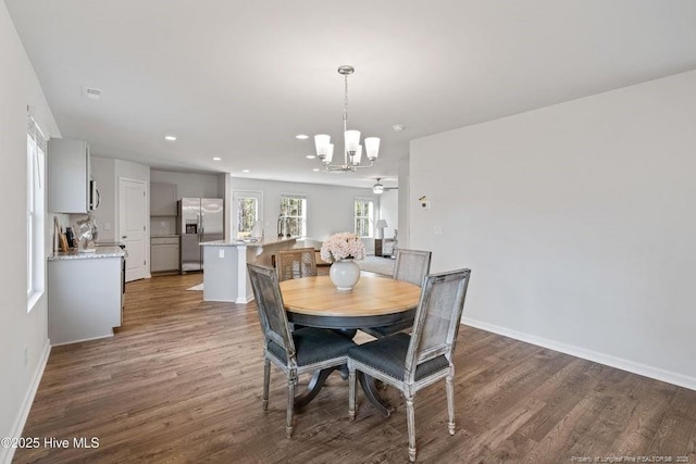 dining room featuring dark wood finished floors, recessed lighting, ceiling fan with notable chandelier, and baseboards