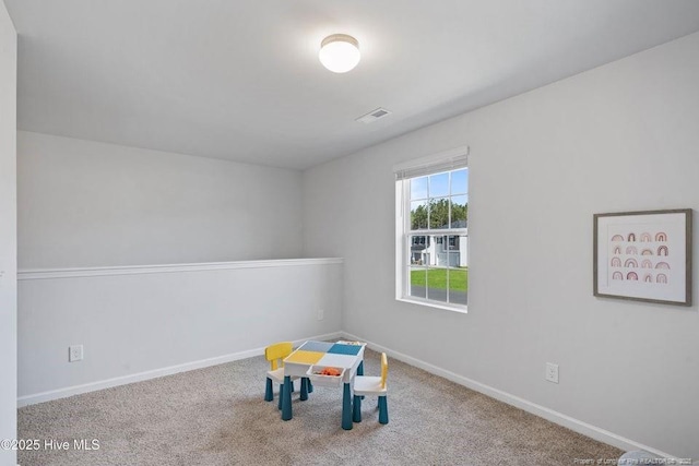 rec room with carpet, visible vents, and baseboards