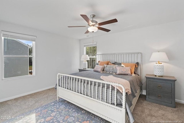 carpeted bedroom featuring ceiling fan and baseboards