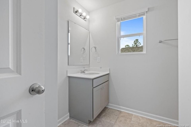 bathroom with vanity and baseboards