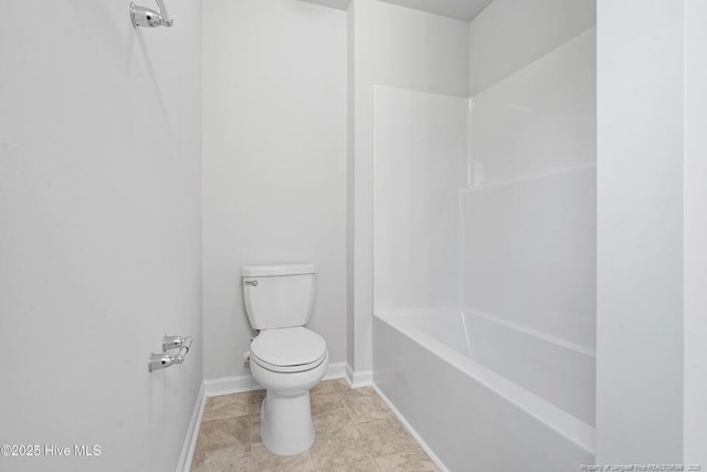 bathroom with tile patterned flooring, toilet, and baseboards