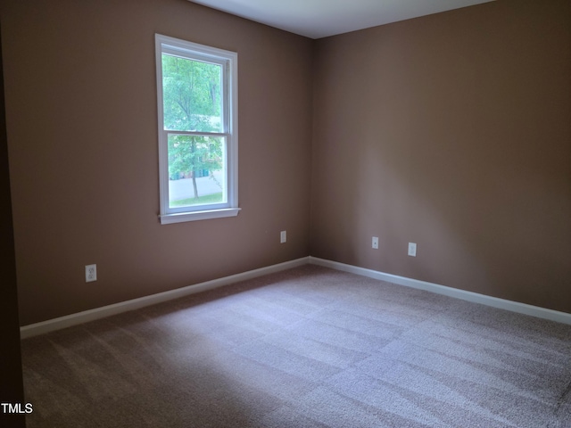 unfurnished room with plenty of natural light and carpet