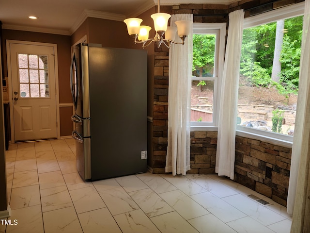 kitchen featuring a chandelier, hanging light fixtures, stainless steel fridge, and light tile floors