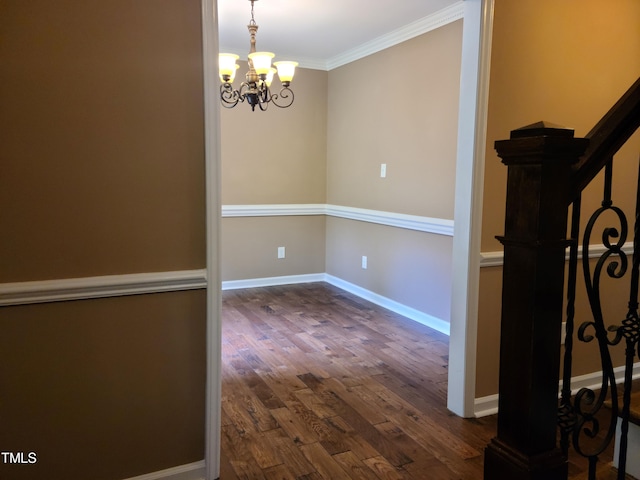 interior space featuring crown molding, dark wood-type flooring, and a notable chandelier