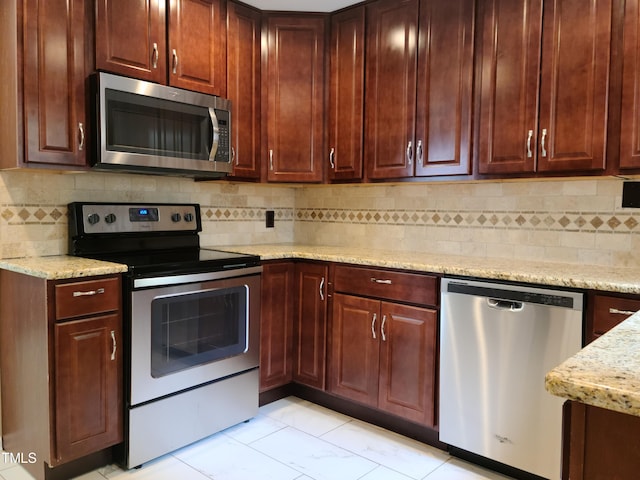 kitchen featuring tasteful backsplash, light tile floors, and stainless steel appliances