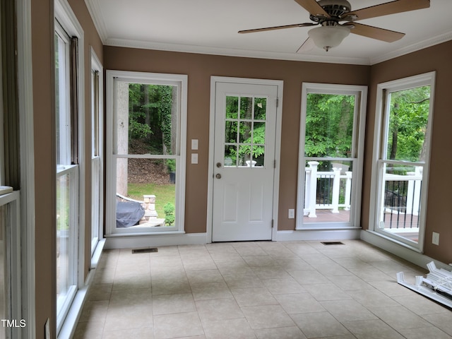 entryway with a healthy amount of sunlight, ceiling fan, and light tile floors