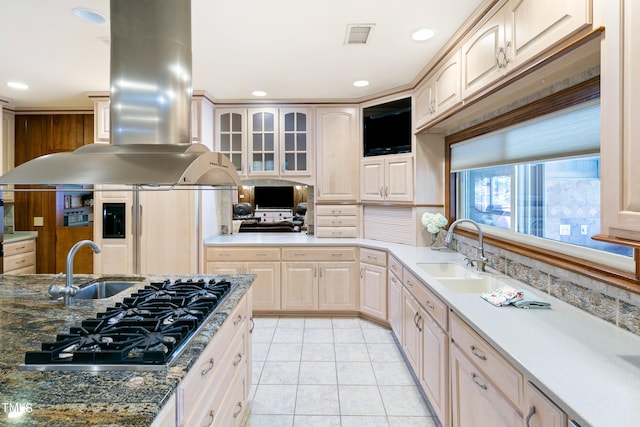 kitchen with stainless steel gas cooktop, island range hood, sink, and light tile flooring