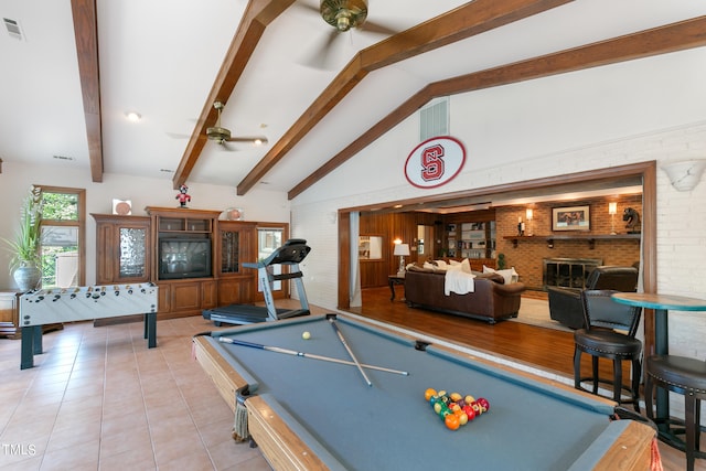 rec room featuring lofted ceiling with beams, light tile flooring, brick wall, billiards, and ceiling fan