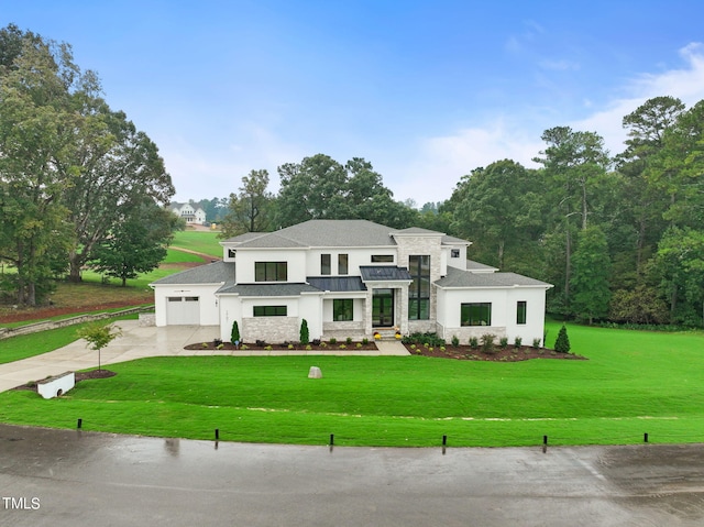 view of front of property featuring a front yard and a garage