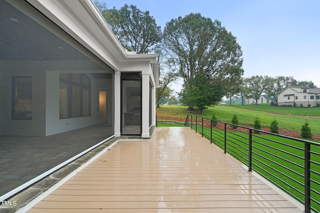 wooden deck featuring a yard