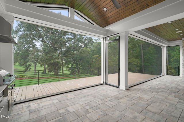 unfurnished sunroom with wood ceiling and vaulted ceiling