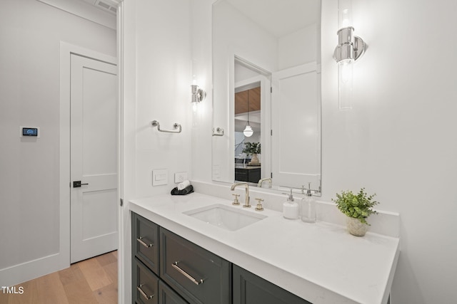 bathroom featuring visible vents, vanity, and wood finished floors