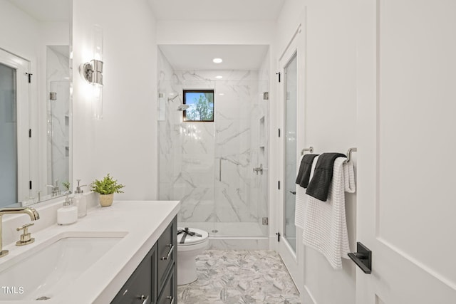 bathroom with toilet, a marble finish shower, and vanity