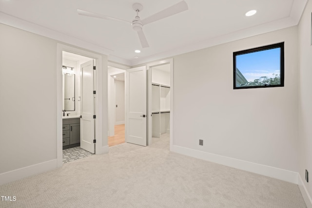 unfurnished bedroom with light carpet, ensuite bath, baseboards, and recessed lighting