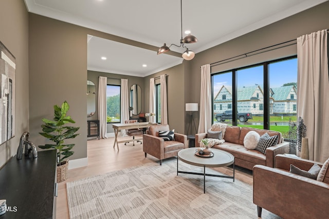 living room with ornamental molding, a city view, plenty of natural light, and baseboards