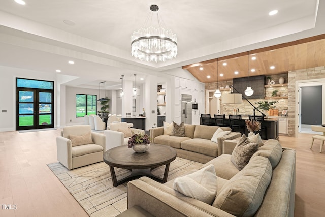 living room with light wood finished floors, baseboards, a chandelier, and recessed lighting