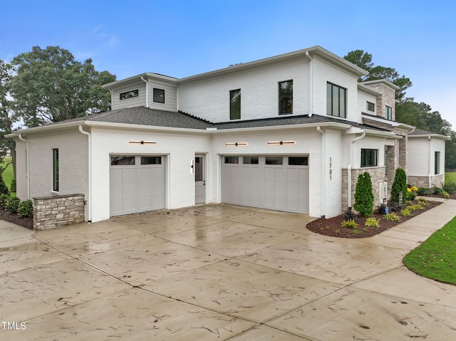 view of front of property featuring stone siding, concrete driveway, brick siding, and an attached garage