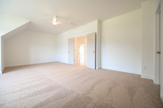 additional living space with ceiling fan, light colored carpet, and lofted ceiling