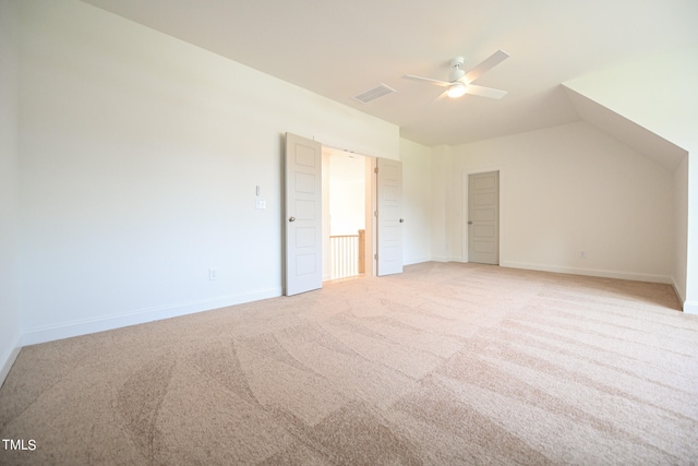 additional living space featuring ceiling fan, light colored carpet, and lofted ceiling