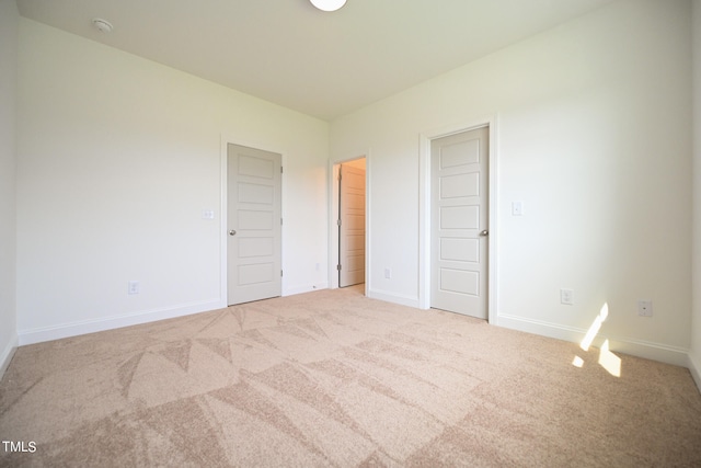 unfurnished bedroom featuring light colored carpet