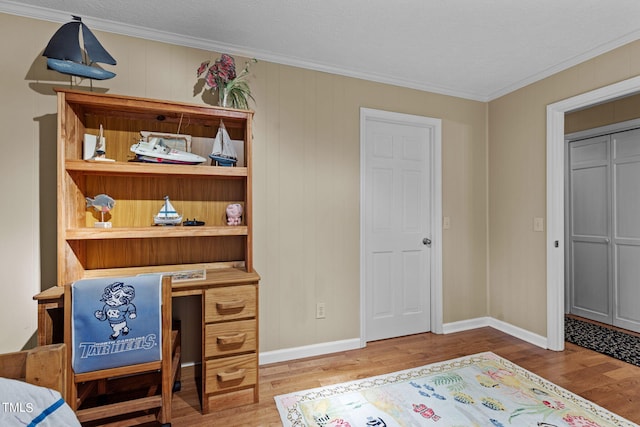 bedroom featuring a textured ceiling, crown molding, and hardwood / wood-style flooring