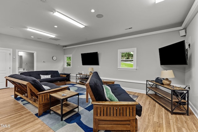 living room featuring a wealth of natural light and light hardwood / wood-style flooring