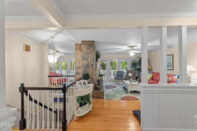 hall featuring beamed ceiling, a textured ceiling, and hardwood / wood-style floors