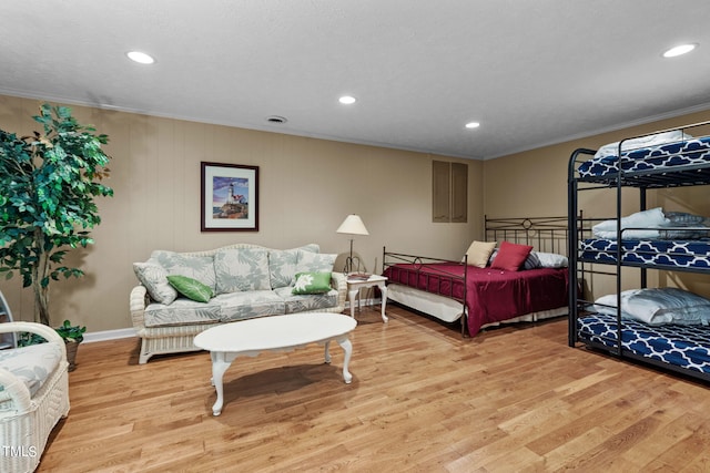 bedroom featuring hardwood / wood-style floors, ornamental molding, and a textured ceiling