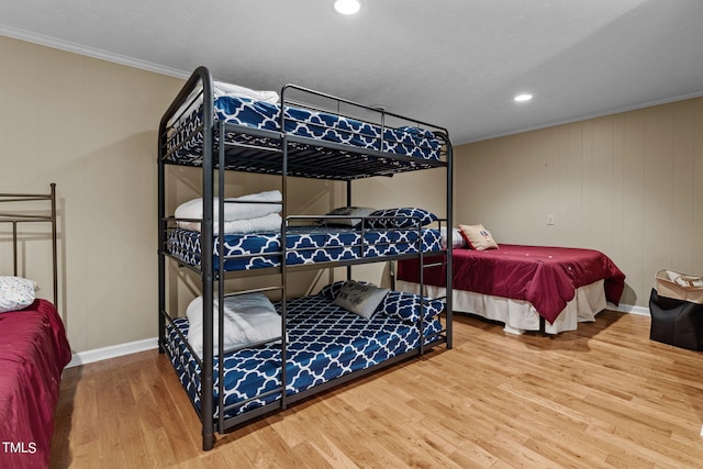 bedroom featuring ornamental molding and hardwood / wood-style flooring