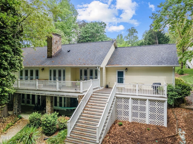 rear view of property featuring a wooden deck