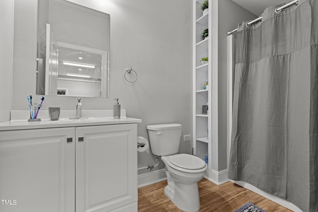 bathroom featuring hardwood / wood-style floors, vanity, and toilet