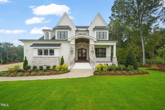 view of front of home featuring french doors, a front lawn, and a porch